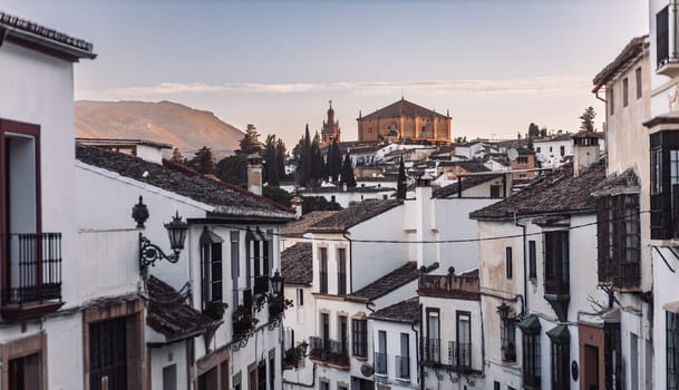 Views of the medieval village of Ronda with white Andalusian houses and the gothic style church of Santuario de Mar a Auxiliadora. Malaga, Spain