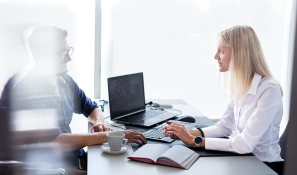 Business meeting. Client consulting. Confident business woman, real estate agent, financial advisor explaining details of project or financial product to client in office