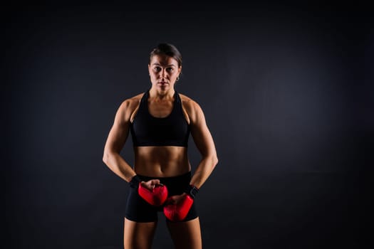 Young woman athletic female MMA fighter is training. Concept of sport, action, healthy lifestyle.