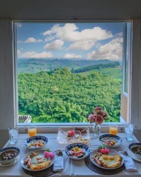 breakfast in the mountains of Northern Thailand. American and Thai breakfast with rice soup,sausages and bread