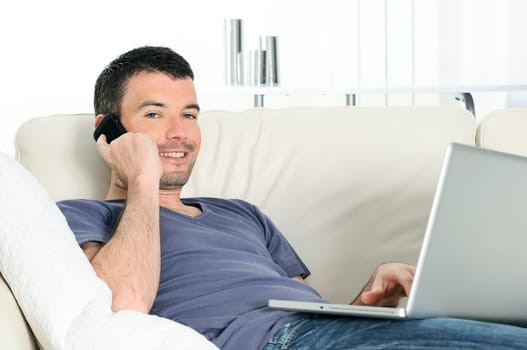 attractive relaxed and positive man is working at home