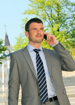 businessman is having a communication with his cellphone