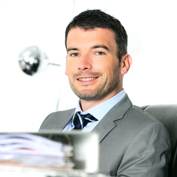 An attractive business man in a light business environment