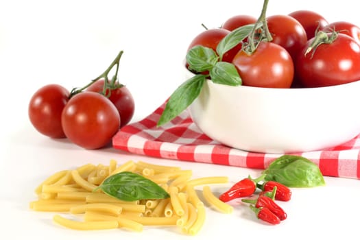 Colorful pasta tomato and basil against white background