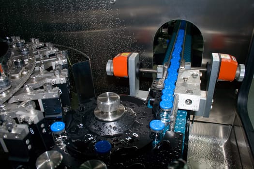 Part of a machine washing bottles at the factory for the production of medicines