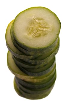 cucumber slices piled one above the other isolated on white