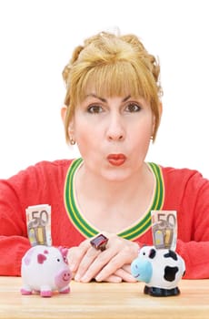 Happy woman saving money with piggy banks. Isolated over white background.
