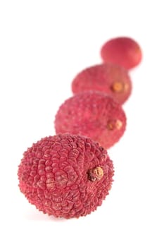 fresh red lychees against white background