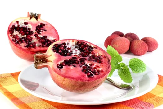 a sliced pomegranate against a white background