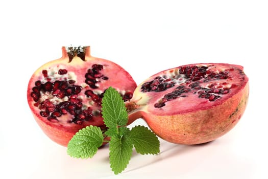 a sliced pomegranate against a white background