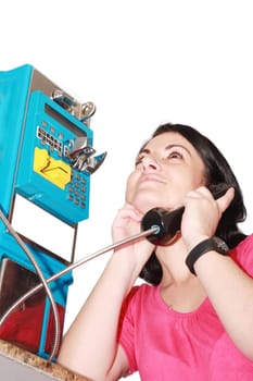 Beautiful woman happy talking on the public phone