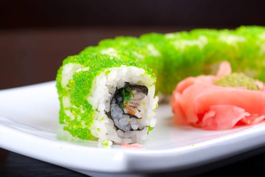 Sushi rolls made of salmon, avocado, flying fish roe - tobiko caviar and philadelphia cheese