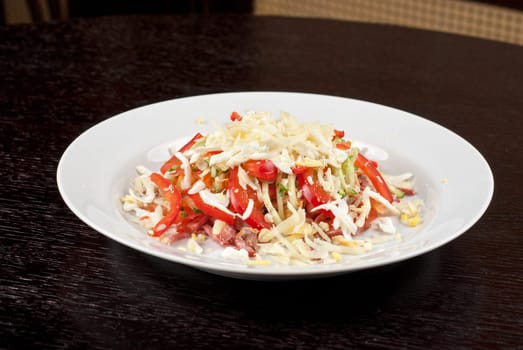 Salad from beef tongue, cervelat, chicken meat, fresh tomatoes, cucumbers, pepper, eggs, cheese and mayonnaise