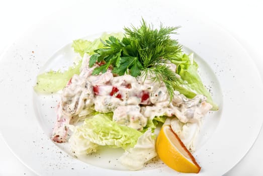 Tasty salad of seafood and vegetable dish close up on a white background