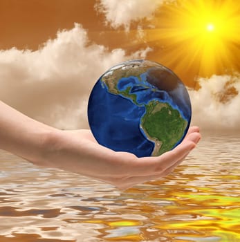 Take care the world concept on a orange sky and dramatic sunset background