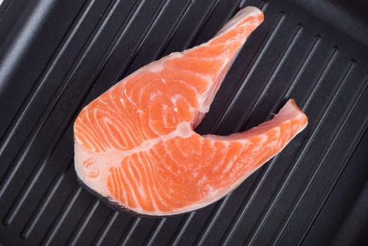 trout steak at grill pan on a white background