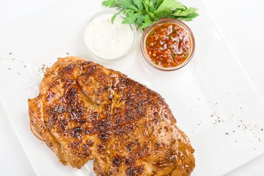delicious grilled chicken at plate with sauce
