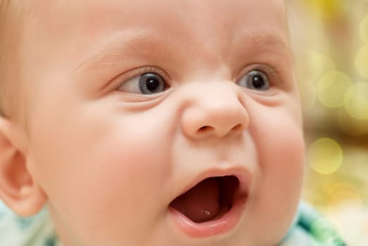 happy baby boy portrait lying at the bed