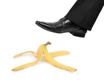 Business risk concept: boot to step on a banana skin