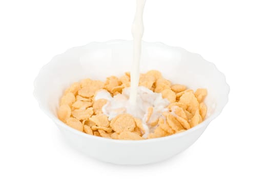 Milk pouring in a bowl of cornflakes closeup