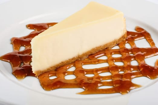 Cheese Cake with honey sauce closeup on white plate