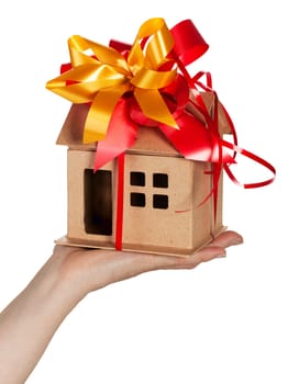 Miniature model concept house resting on a female hand,Isolated On White