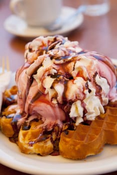 Delicious waffles with ice cream and whipped cream