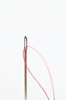 Sewing needle with red thread