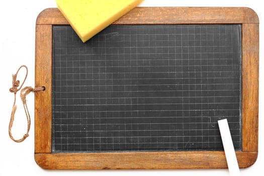 Old slate from school with chalk,sponge and apple