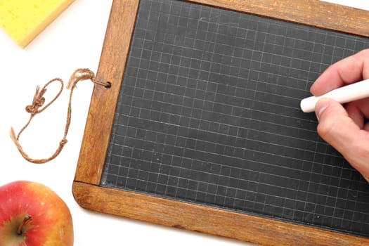 Old slate from school with chalk,sponge and apple