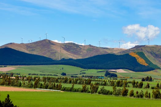 Image of a wind farm perched on top of a hillside in New Zealand