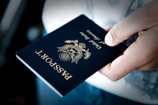 Image of a person&#039 s hand holding a passport
