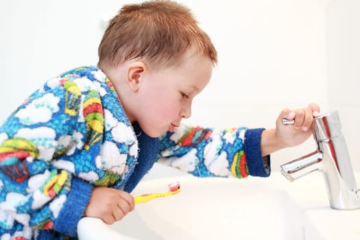 Dental care - small boy washing his teeth