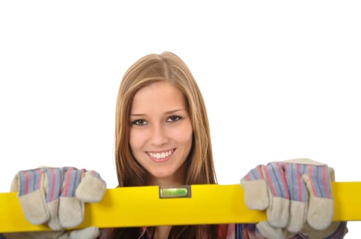 Smiling young woman with brown eyes holding a spirit level