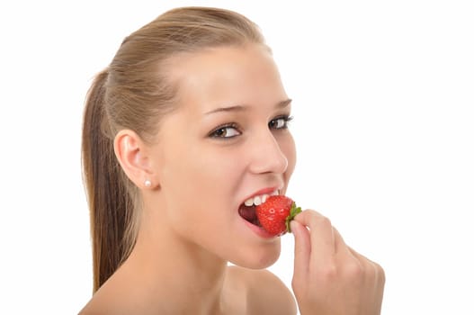 Young woman with ponytail biting into a red strawberry