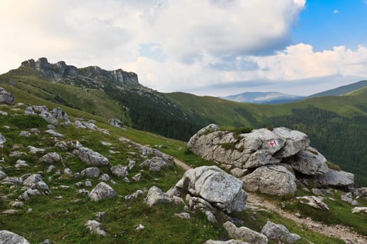 mountain landscape and a blue sky with clouds