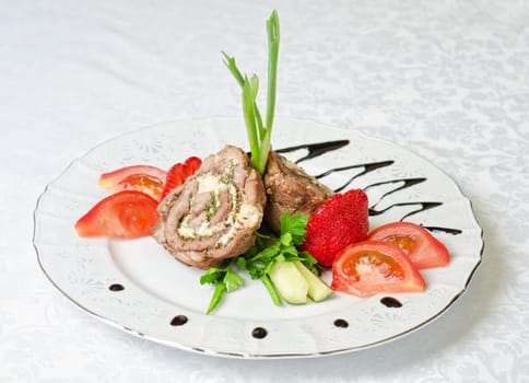 Pork rolls with cheese and vegetables: onion, cucumbers, tomatoes