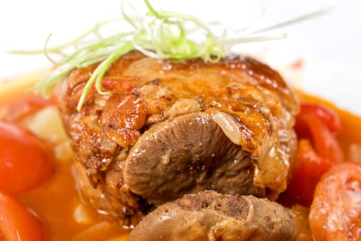 knuckle of veal baked with vegetables closeup