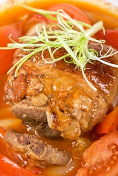knuckle of veal baked with vegetables closeup