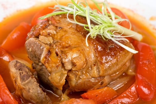 knuckle of veal baked with vegetables closeup