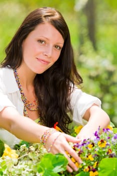 Summer garden beautiful young woman smiling flowers