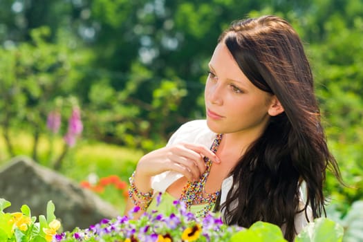 Summer garden colorful flowers beautiful young woman dreamy look