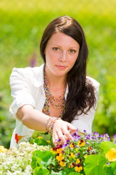 Summer garden beautiful young woman smiling flowers