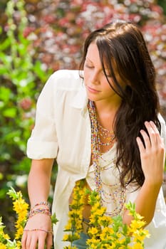 Beautiful young woman sunny garden care yellow flower portrait