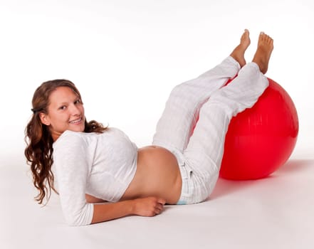 Pregnant young woman with ball