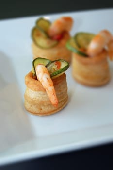 appetizer with Zucchini and shrimps on a white plate