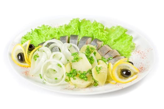 Herring with potato and vegetables isolated on a white background