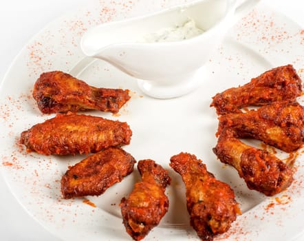 chicken grilled wings with sauce closeup at white plate