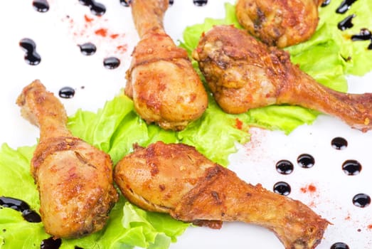 chicken wings closeup at white plate with lettuce