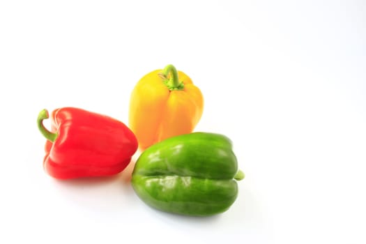 Different colored peppers isolated against neutral background